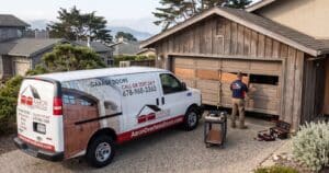 Technician replacing garage door panel central coast