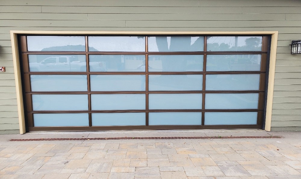 White laminate glass garage door with bronze aluminum frame